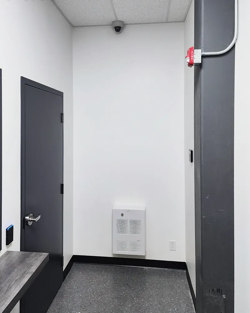 Access-controlled commercial door with surveillance camera